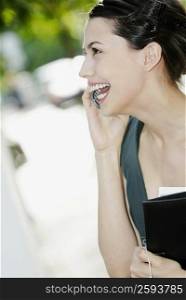 Close-up of a young woman talking on a mobile phone and smiling