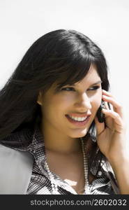 Close-up of a young woman talking on a mobile phone and smiling