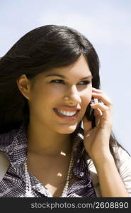 Close-up of a young woman talking on a mobile phone and smiling