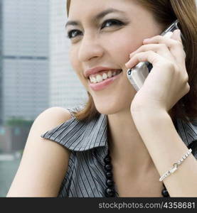 Close-up of a young woman talking on a mobile phone and smiling