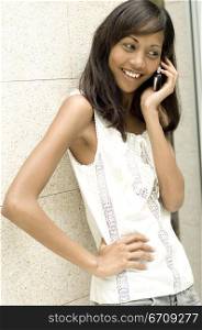 Close-up of a young woman talking on a mobile phone and smiling