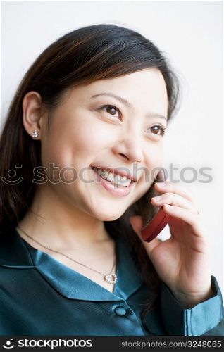 Close-up of a young woman talking on mobile phone