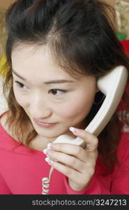 Close-up of a young woman talking on the telephone