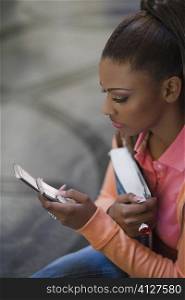 Close-up of a young woman text messaging