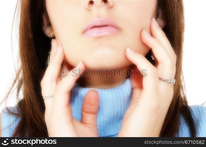 Close-up of a young woman touching her face