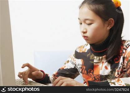 Close-up of a young woman using a computer