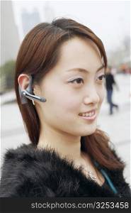 Close-up of a young woman wearing a hands free device