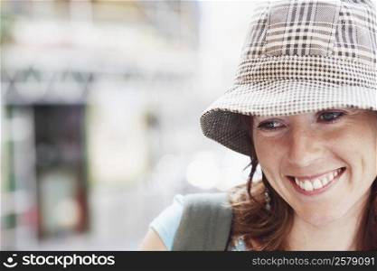 Close-up of a young woman wearing a hat