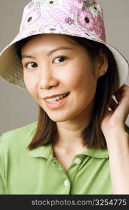 Close-up of a young woman wearing a hat