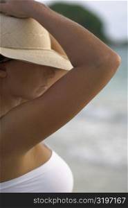 Close-up of a young woman wearing a sun hat