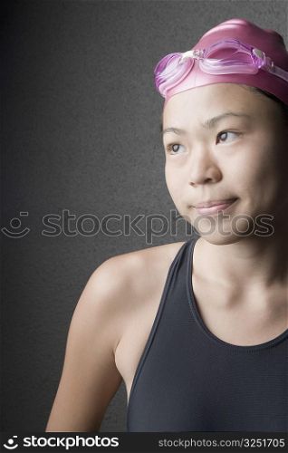 Close-up of a young woman wearing a swimming cap