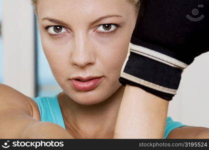 Close-up of a young woman wearing boxing gloves