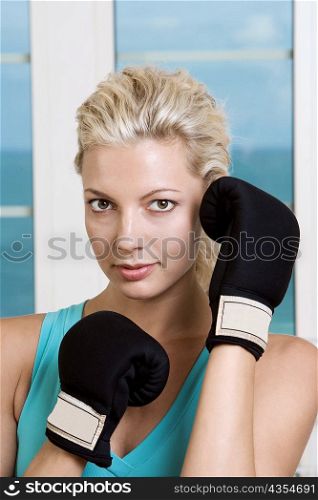 Close-up of a young woman wearing boxing gloves
