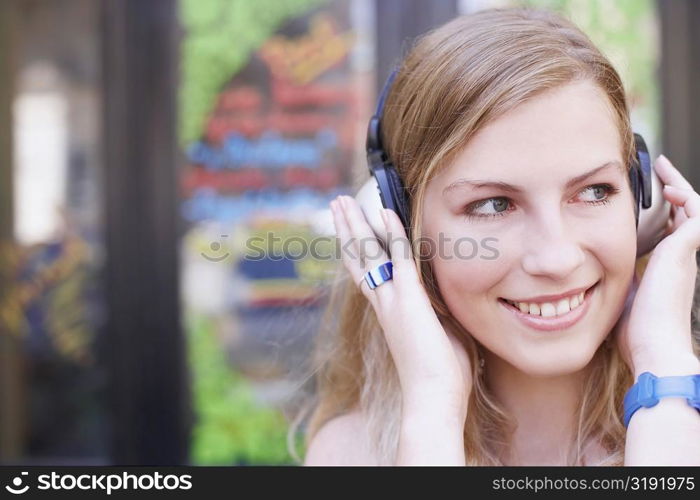 Close-up of a young woman wearing headphones