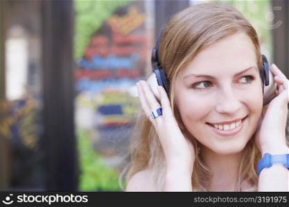 Close-up of a young woman wearing headphones