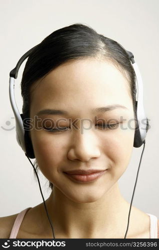 Close-up of a young woman wearing headphones