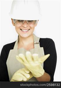 Close-up of a young woman wearing protective gloves