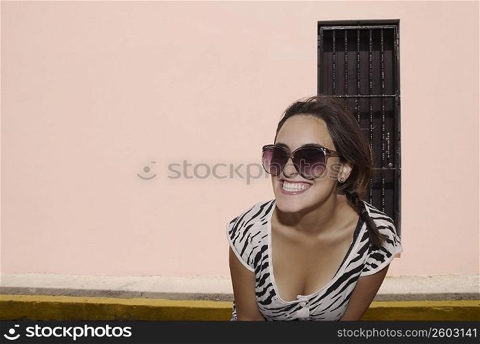 Close-up of a young woman wearing sunglasses and smiling