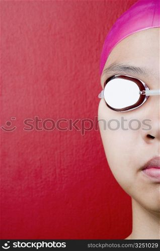 Close-up of a young woman wearing swimming goggles