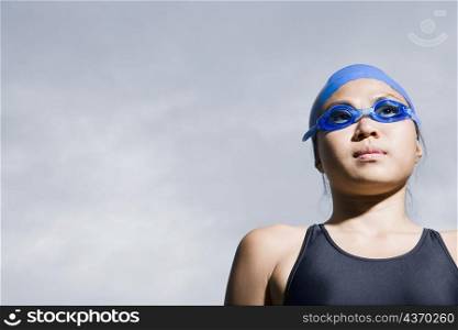 Close-up of a young woman wearing swimming goggles