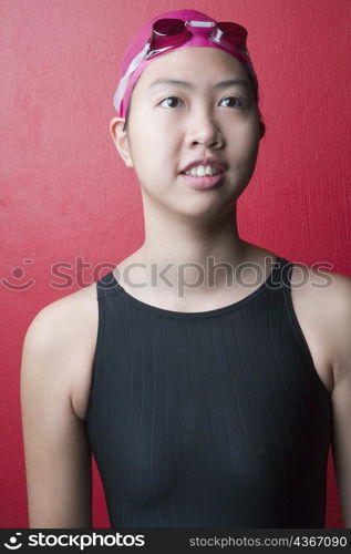 Close-up of a young woman wearing swimwear and smiling