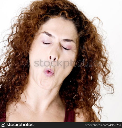 Close-up of a young woman whistling