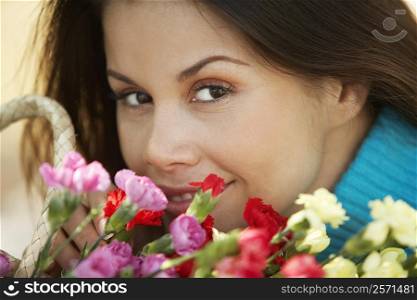 Close-up of a young woman with a bouquet of flowers