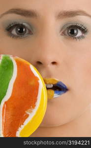 Close-up of a young woman with a lollipop