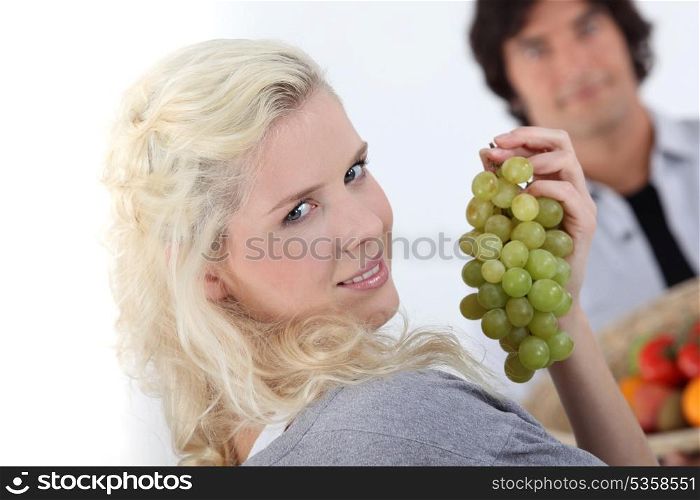 close-up of a young woman with grapes