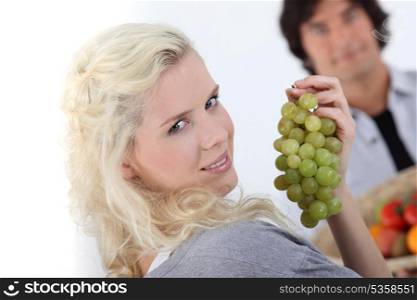 close-up of a young woman with grapes