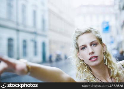 Close-up of a young woman with her arm stretched out