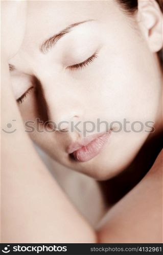 Close-up of a young woman with her eyes closed