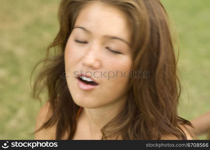 Close-up of a young woman with her eyes closed