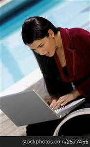 Close-up of a young woman working on a laptop
