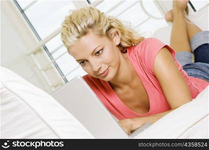 Close-up of a young woman working on a laptop