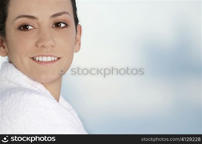Close-up of a young woman wrapped in a towel