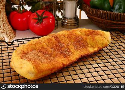 Close-up of a yummy golden brown flat loaf of sugary cinnamon bread.