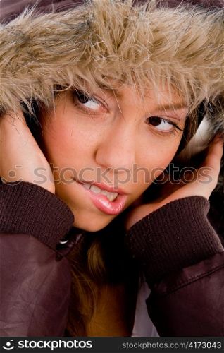 close up of adult woman with woolen coat listening music on an isolated white background