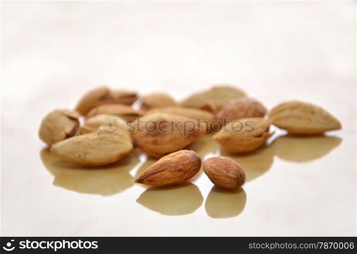 Close up of almonds on the wooden floor. Almonds