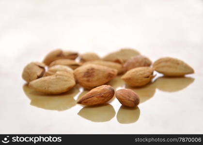 Close up of almonds on the wooden floor. Almonds