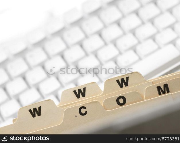 Close-up of alphabet tabs of a file in front of a computer keyboard