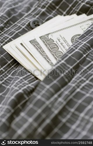 Close-up of American one hundred dollar bills with a checked cloth