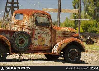 Close-up of an abandoned pick-up truck parked on a field