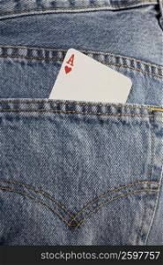 Close-up of an ace playing card in the pocket of a pair of jeans