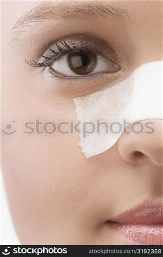 Close-up of an adhesive bandage on a patient&acute;s nose