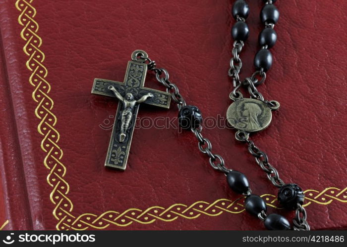 Close up of an antique rosary on an old bible