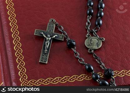 Close up of an antique rosary on an old bible