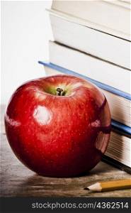 Close-up of an apple near a stack of books