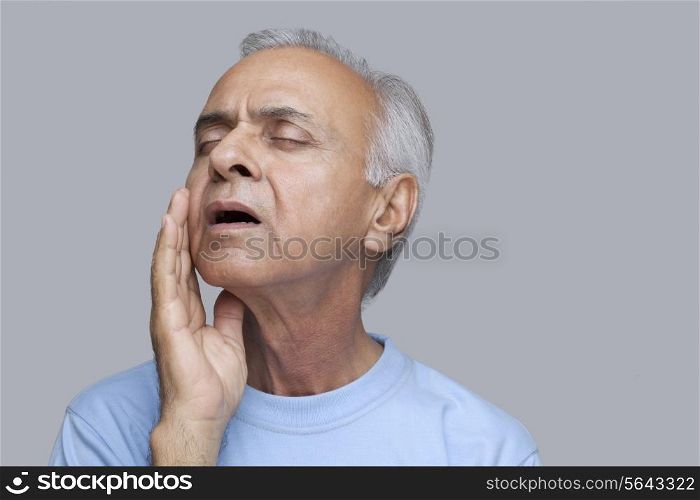 Close-up of an elderly man suffering from a toothache