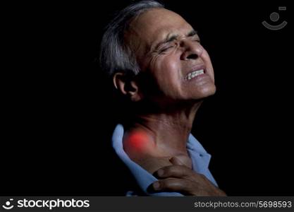 Close-up of an elderly man suffering from shoulder pain